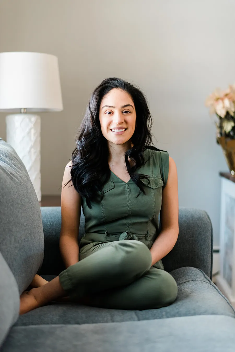 Kristin Otero, occupational therapist and owner of SMPLY Therapy, sitting on a sofa