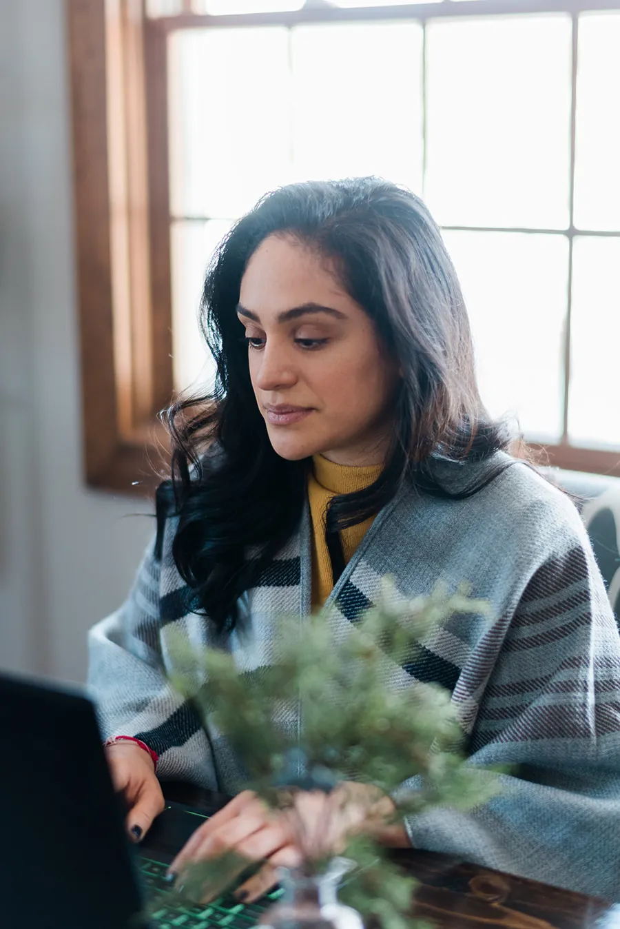 Kristin Otero working at a laptop